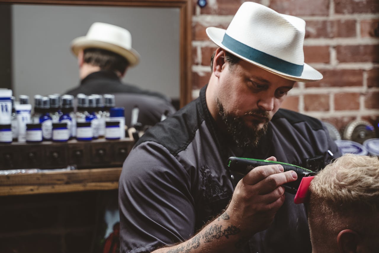 Experienced barber giving a detailed haircut in a stylish barbershop setting.